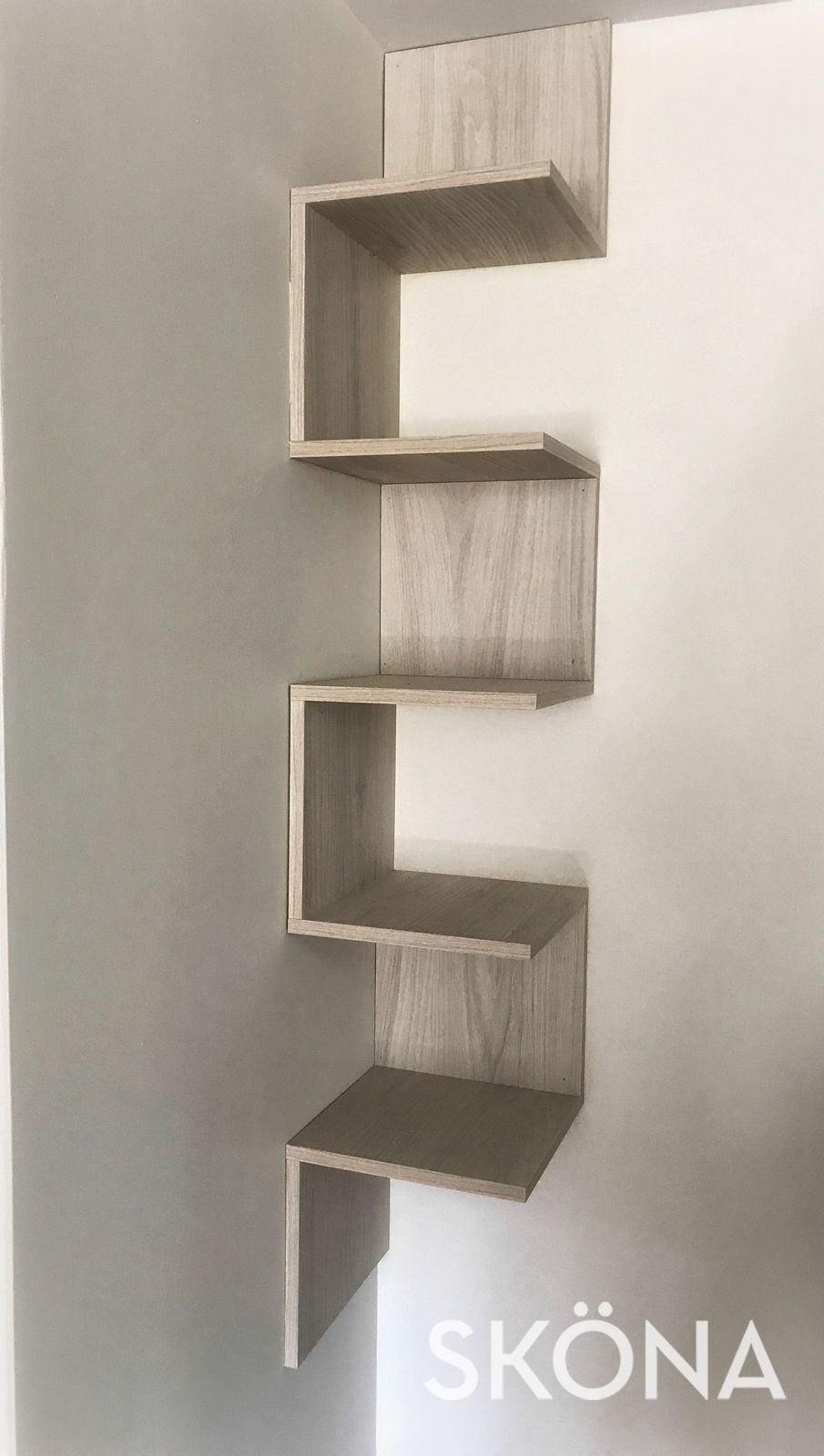 a wooden shelf sitting on top of a wall