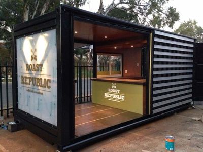 a large shipping container with a bar inside of it