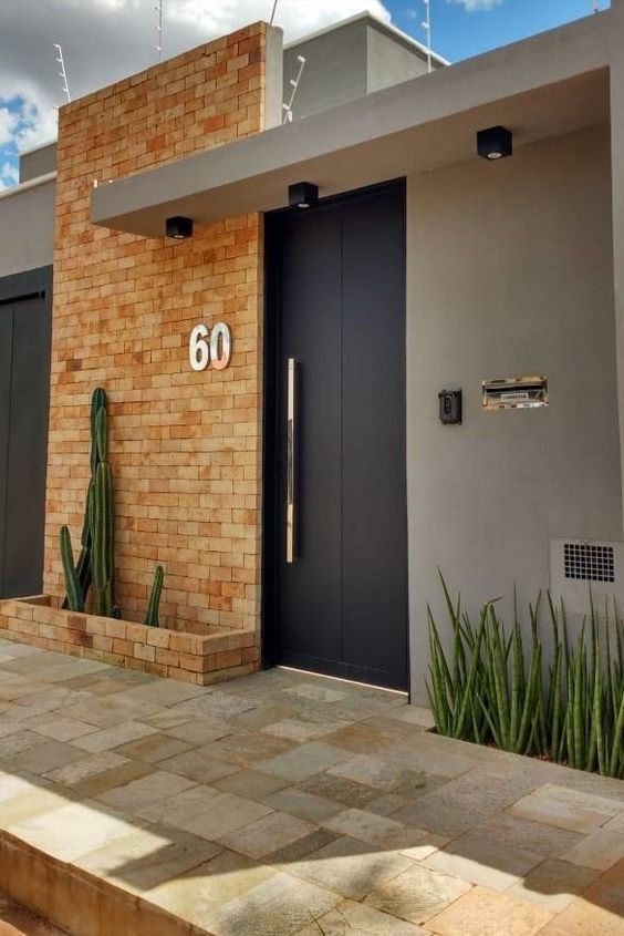 a brick building with a black door and number 60 on it