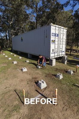 a man kneeling down next to a box truck