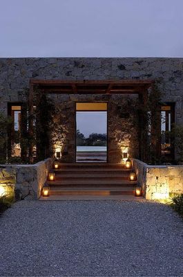 a stone building with steps lit up at night