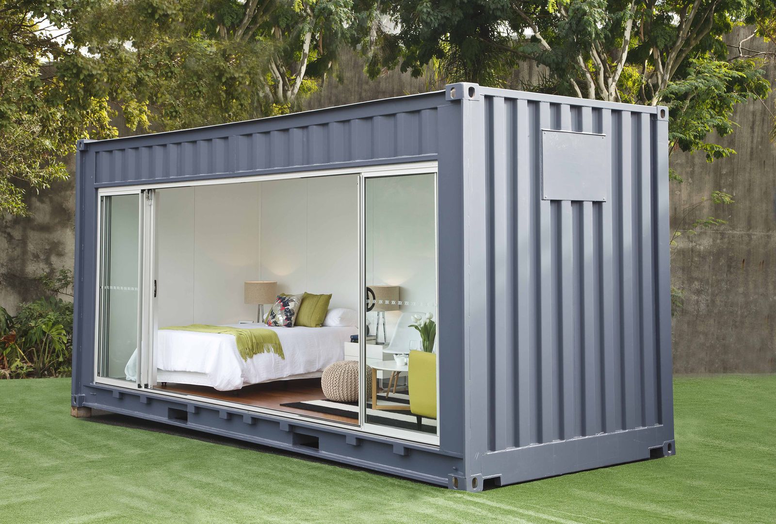 a large blue shipping container with a bed inside of it