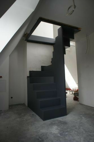 a room with a stair case in the middle of it