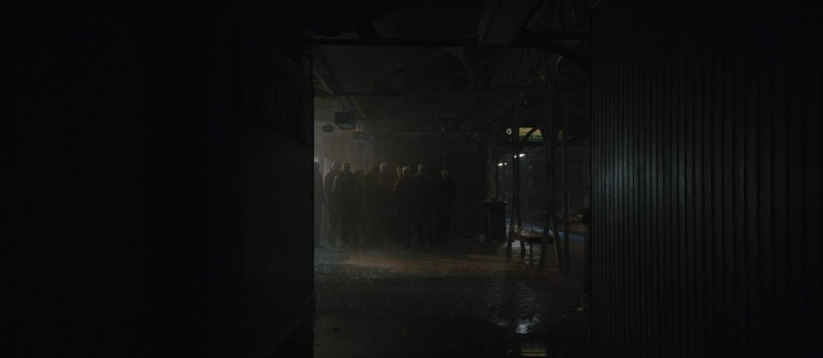 a group of people standing in a dark room