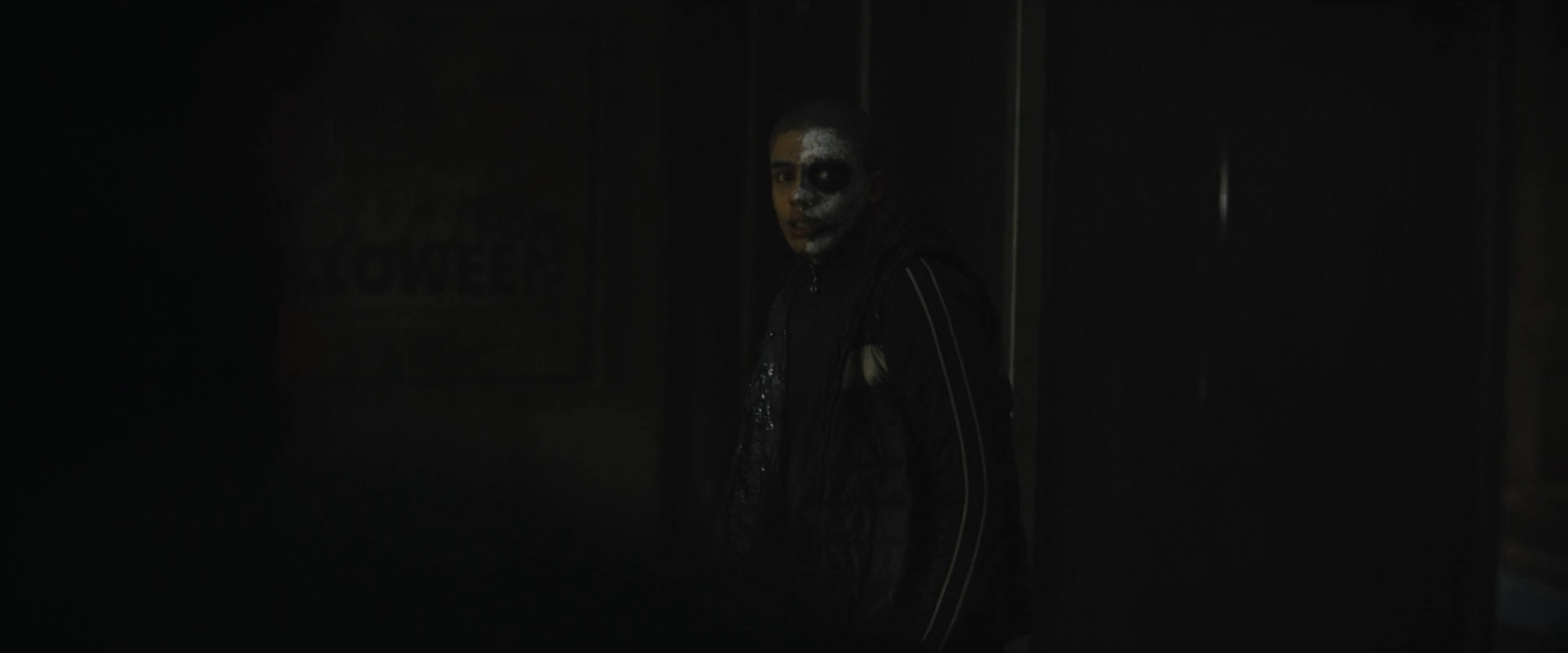 a creepy looking person standing in a dark room