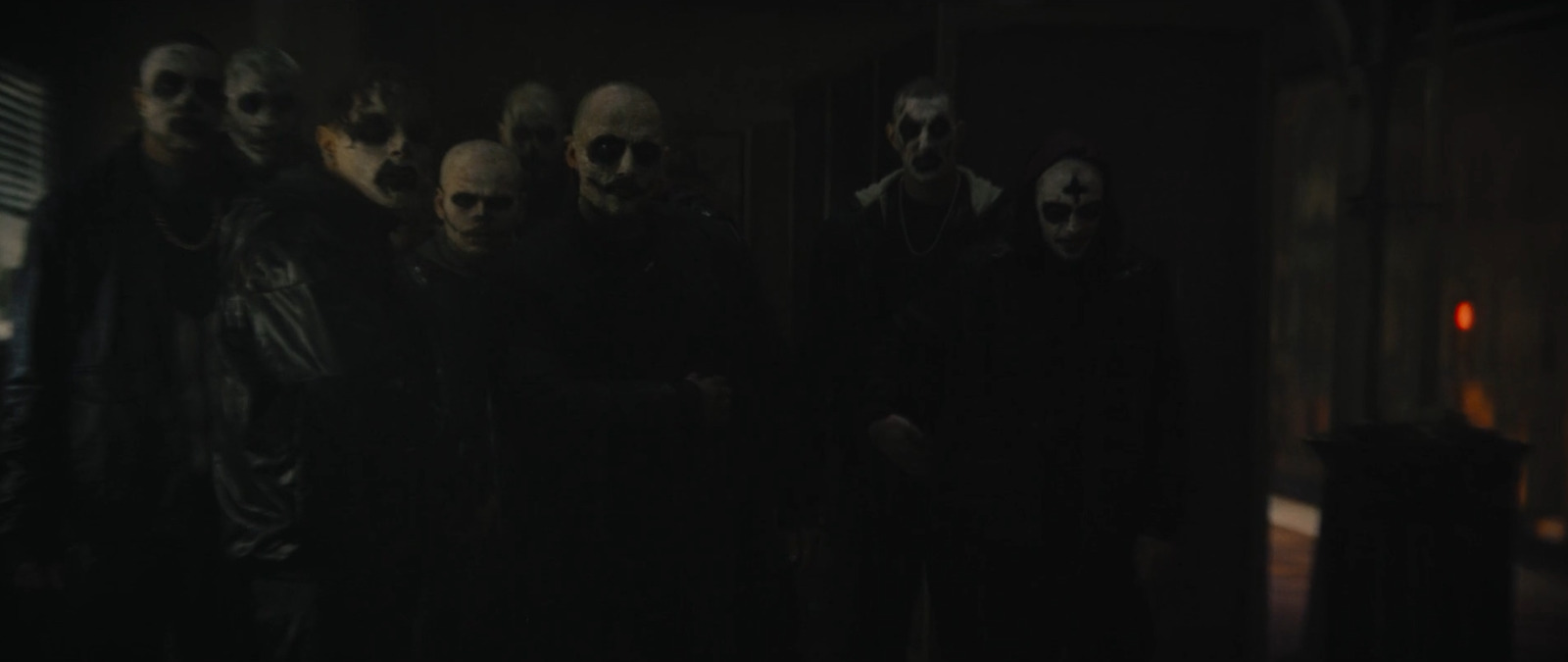 a group of people standing in a dark room