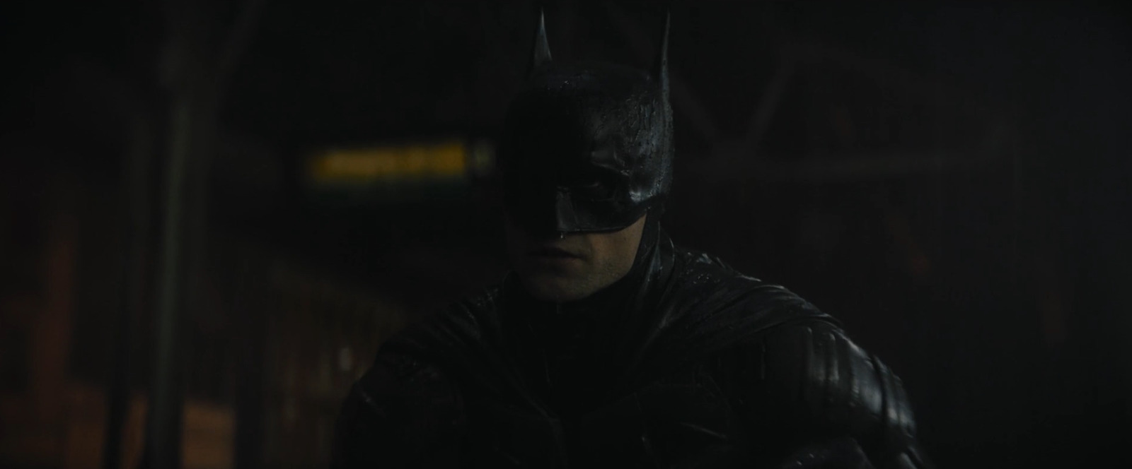 a man in a batman costume standing in the dark