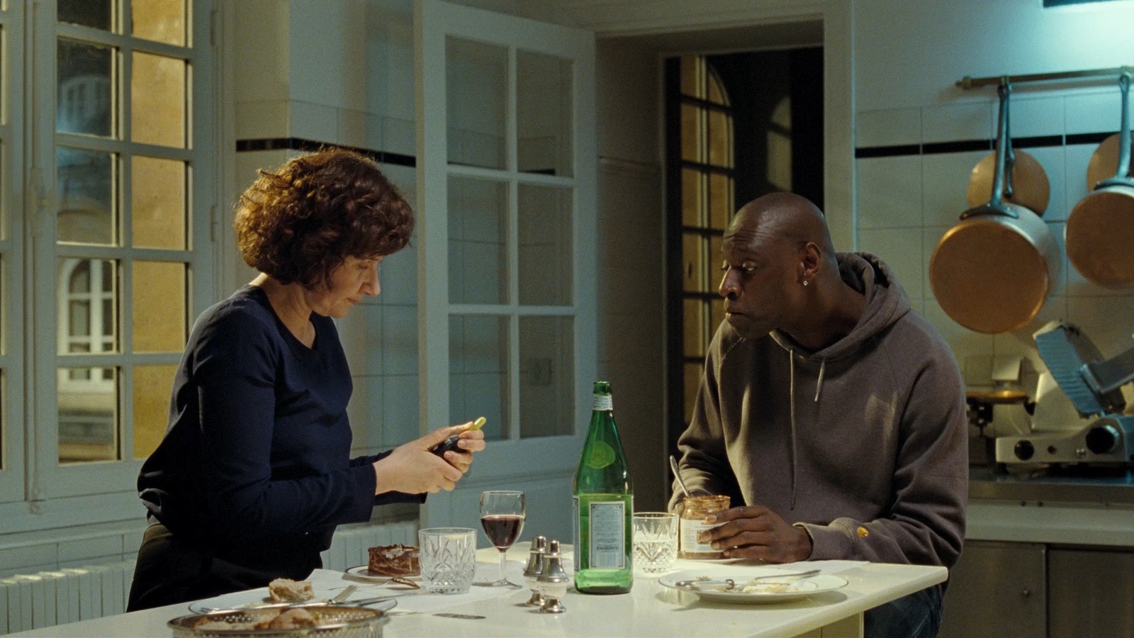 a man and a woman sitting at a table in a kitchen