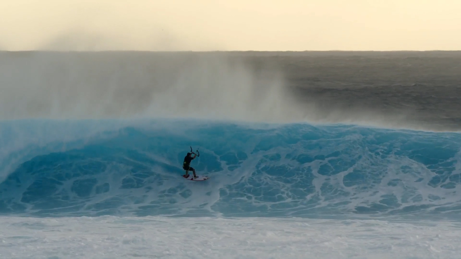 a man riding a wave on top of a surfboard