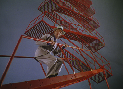 a man standing on a red metal structure