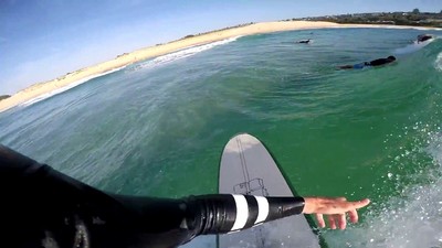 a man riding a surfboard on top of a wave in the ocean