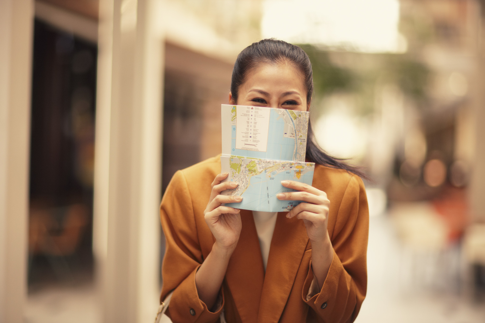 a woman holding a map and looking at it