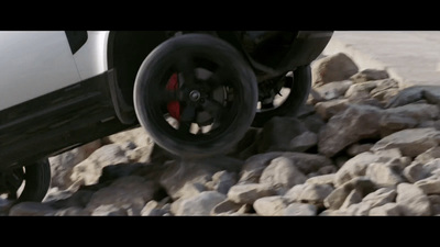 a white truck driving down a rocky road