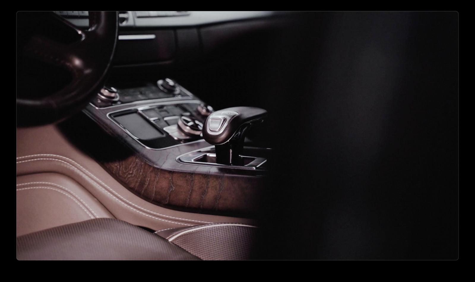 a car dashboard with a steering wheel and a remote control