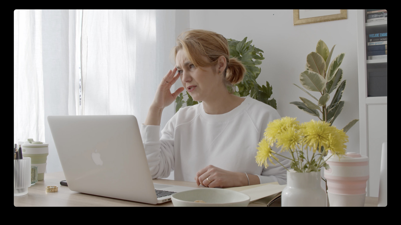 a woman sitting in front of a laptop computer