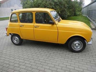 a small yellow car parked on a brick road