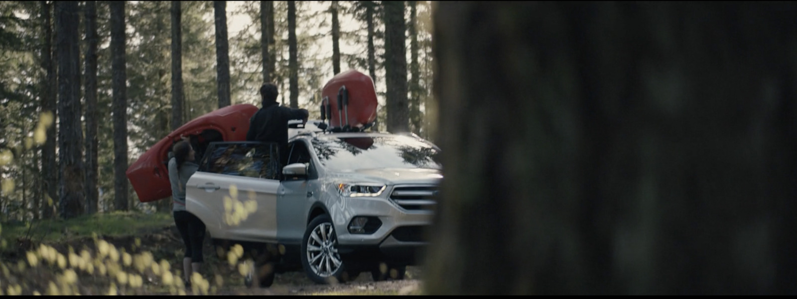 a white truck with a kayak on the back of it