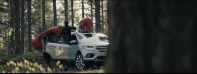 a white truck with a kayak on the back of it