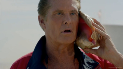 a man in a red jacket talking on a cell phone