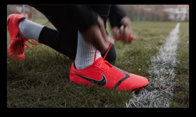 a soccer player tying his shoes before a game