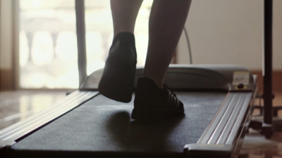 a person walking on a treadmill in a room