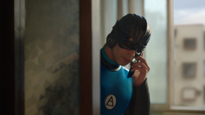 a man in a wet suit talking on a cell phone