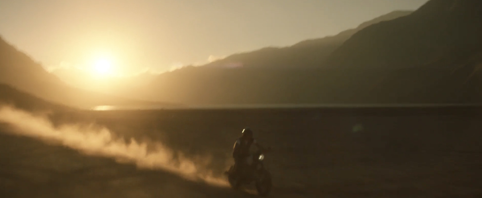 a person riding a motorcycle on a dirt road