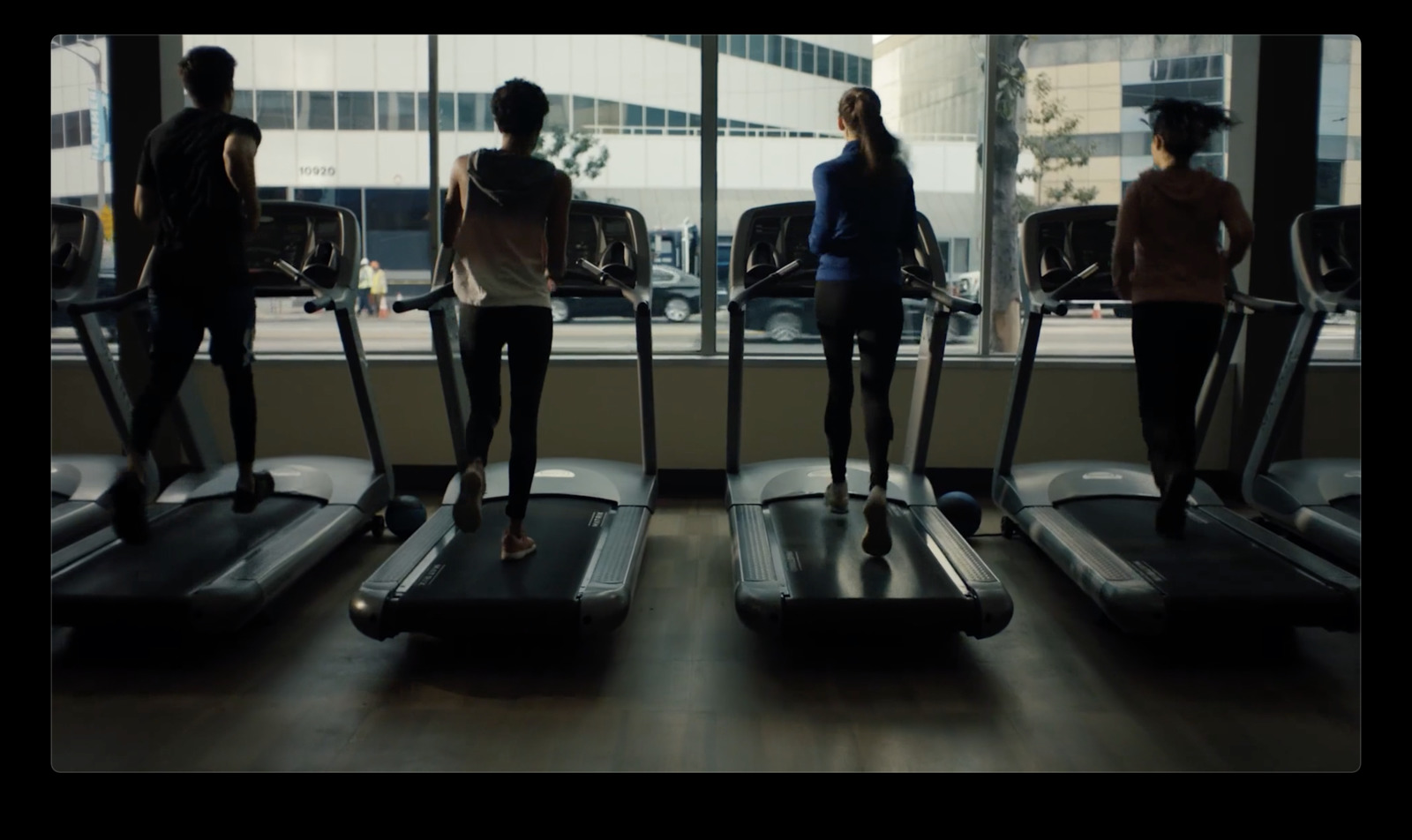 a group of people on treadmills in a gym