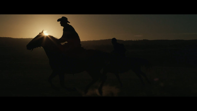 a couple of people riding on the backs of horses