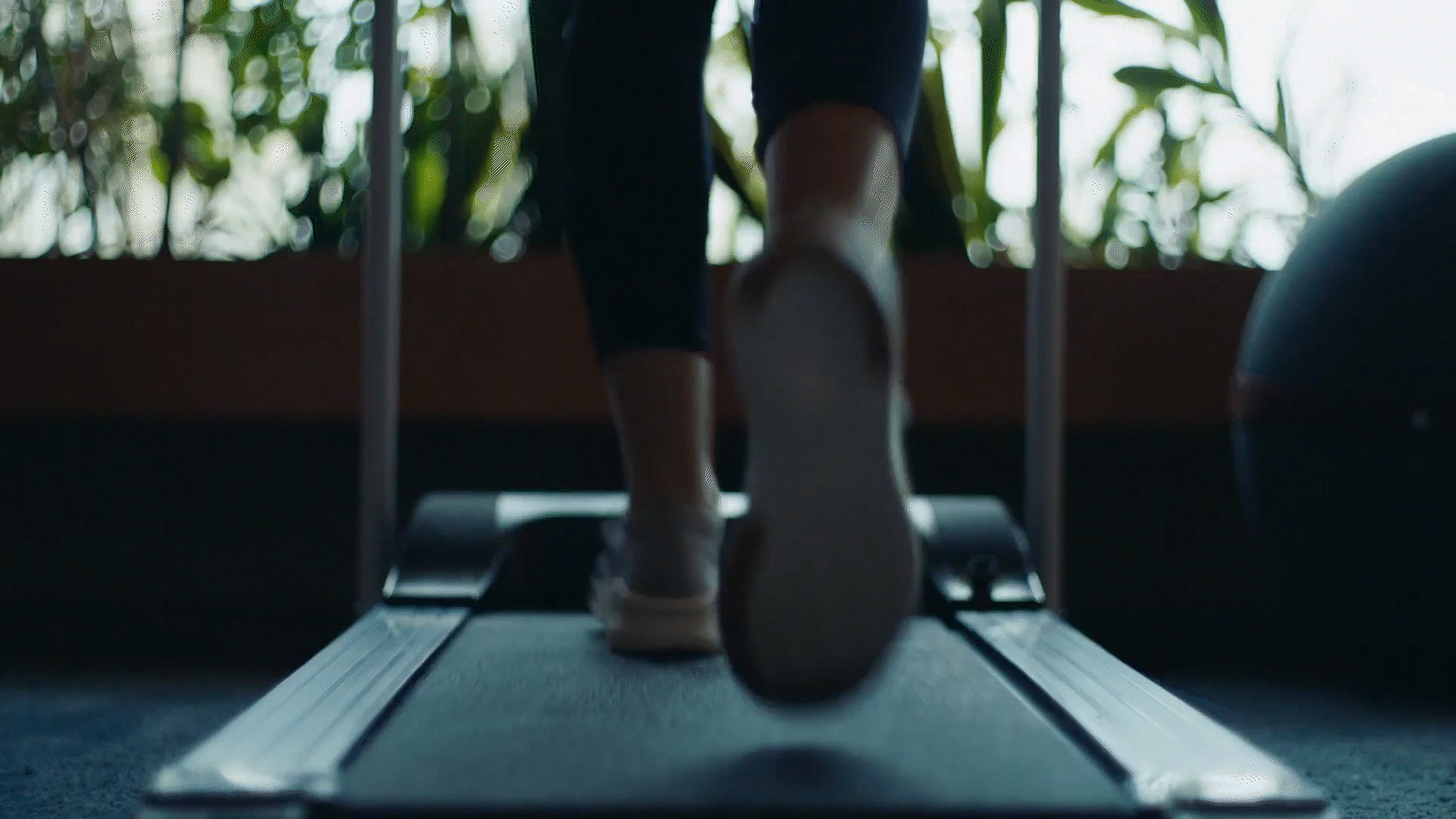 a person standing on a treadmill in a room