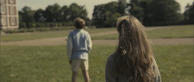 a man and a woman standing in a field