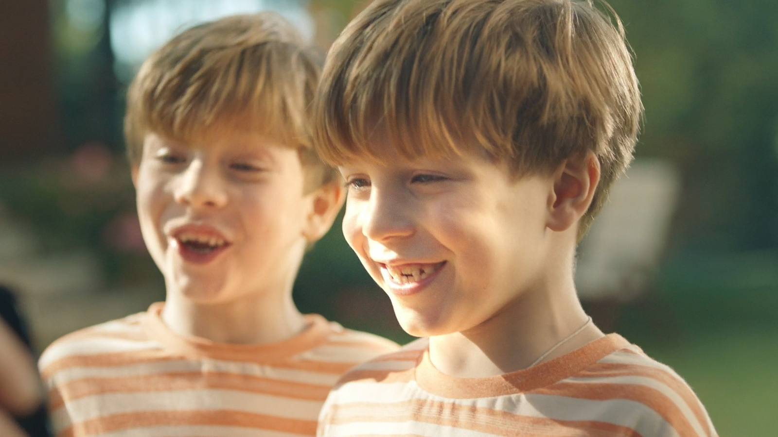 a couple of young boys standing next to each other