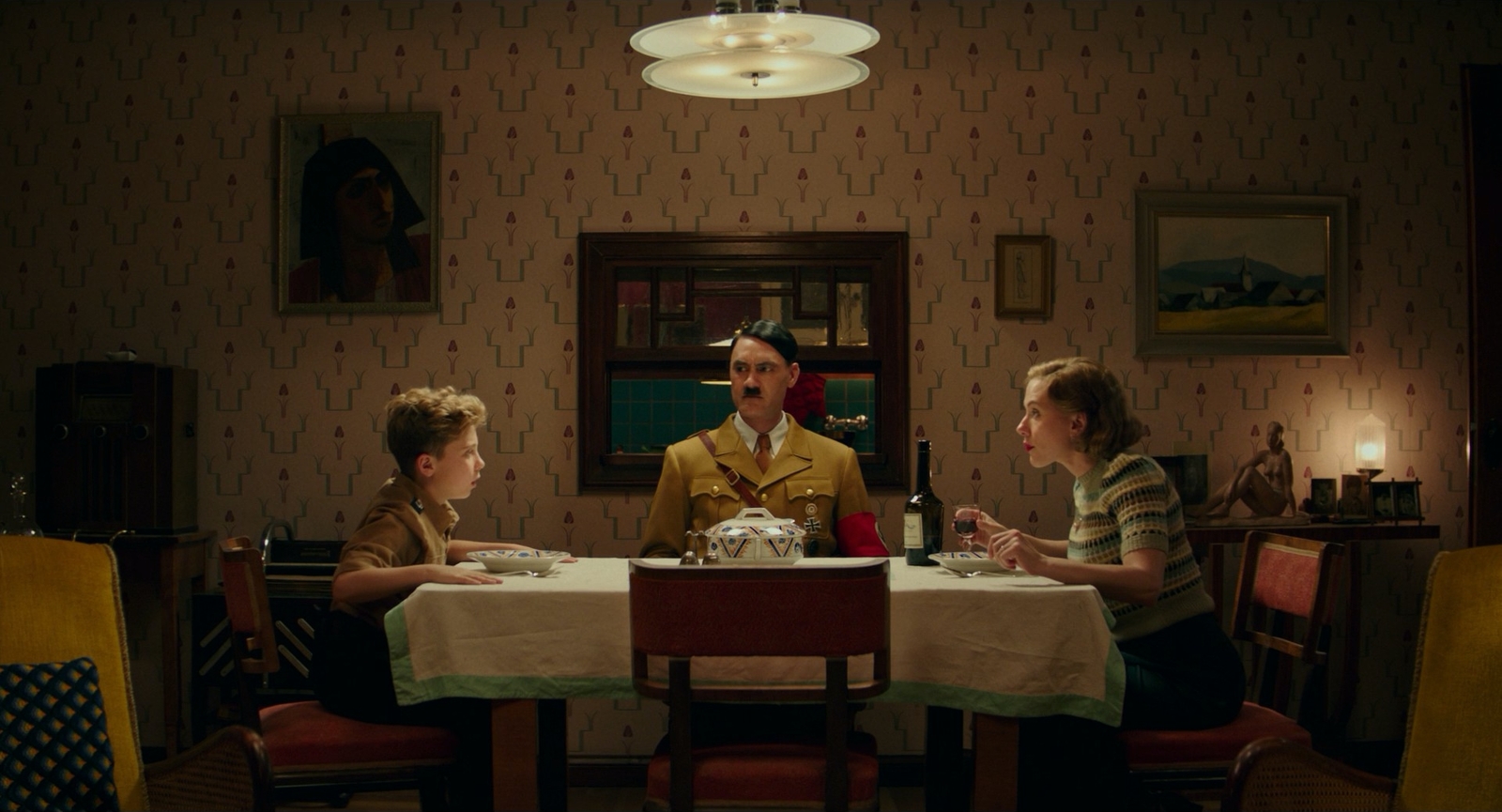 a man and two women sitting at a table