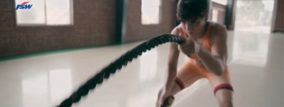 a woman is holding a hose in a room