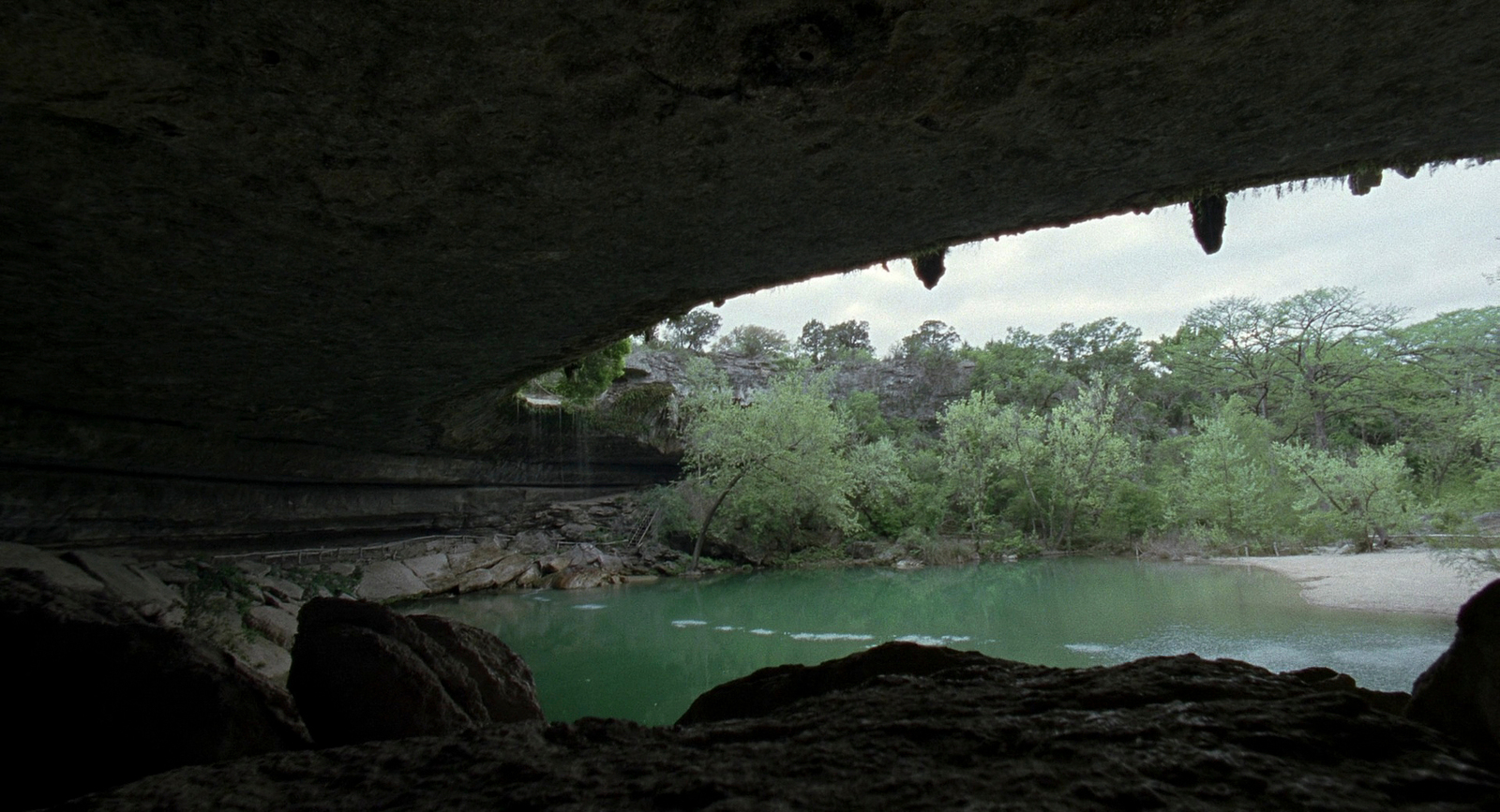 a view of a river from inside a cave