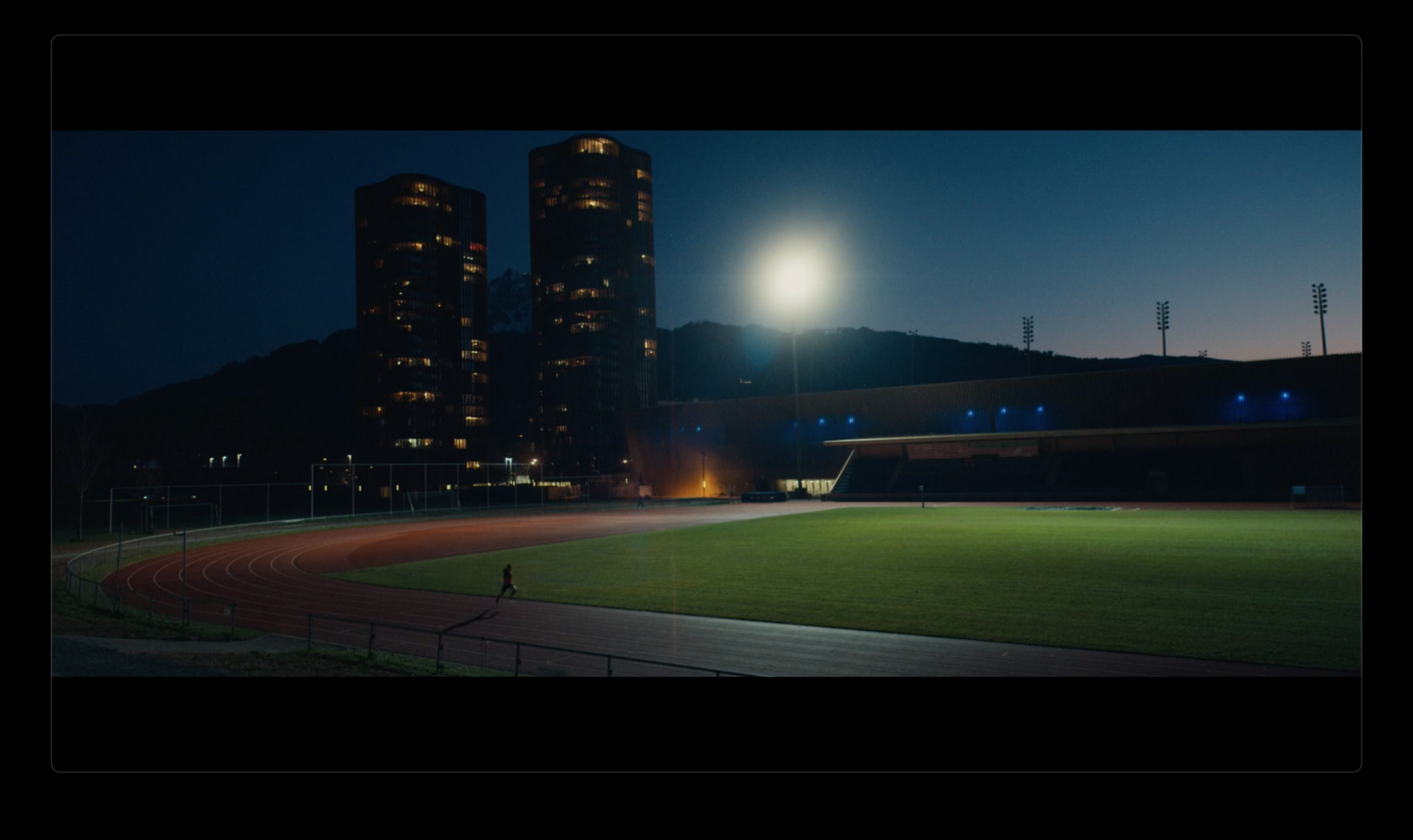 a stadium at night with the lights on