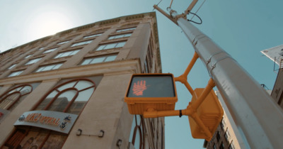 a traffic light sitting next to a tall building