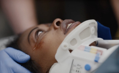 a woman getting her head examined by a doctor