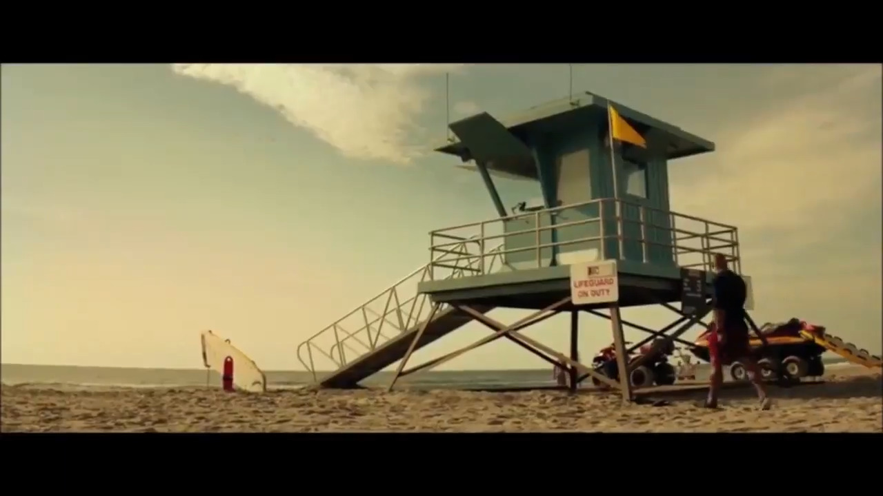 a lifeguard tower sitting on top of a sandy beach