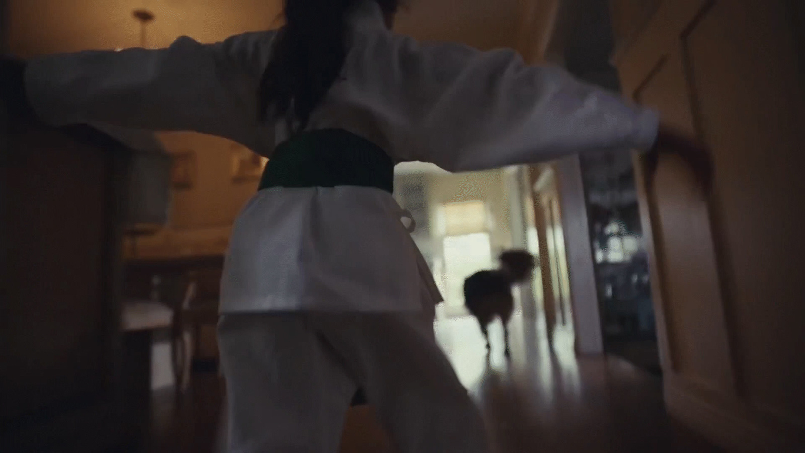 a woman in a white kimono standing in a living room