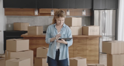 a woman standing in a room full of boxes