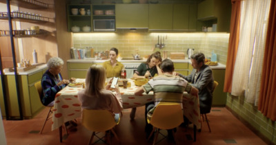 a group of people sitting around a kitchen table