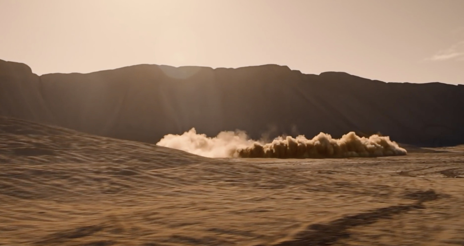 a desert scene with dust coming out of the ground