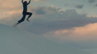 a man riding a snowboard down a snow covered slope