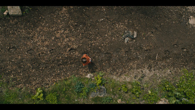 an aerial view of a man standing in the middle of a field