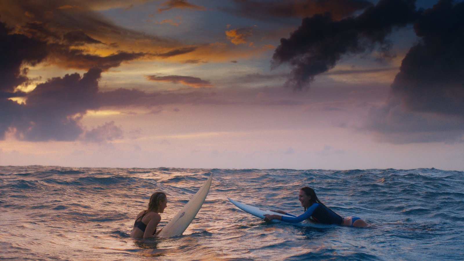 a couple of people on surfboards in the water