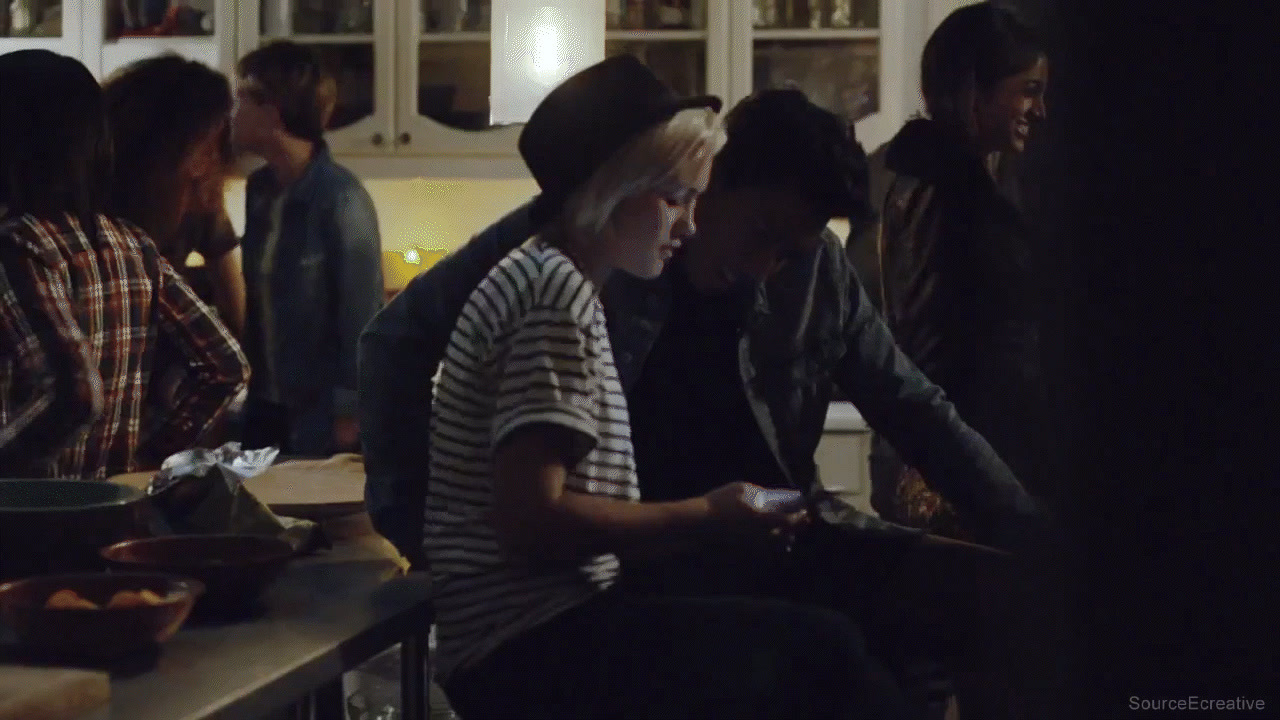 a group of people standing around a kitchen