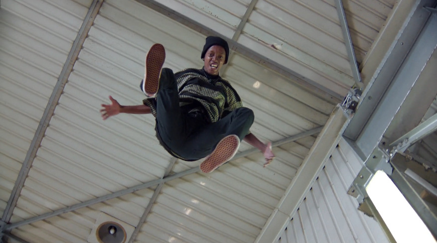 a man flying through the air while riding a skateboard