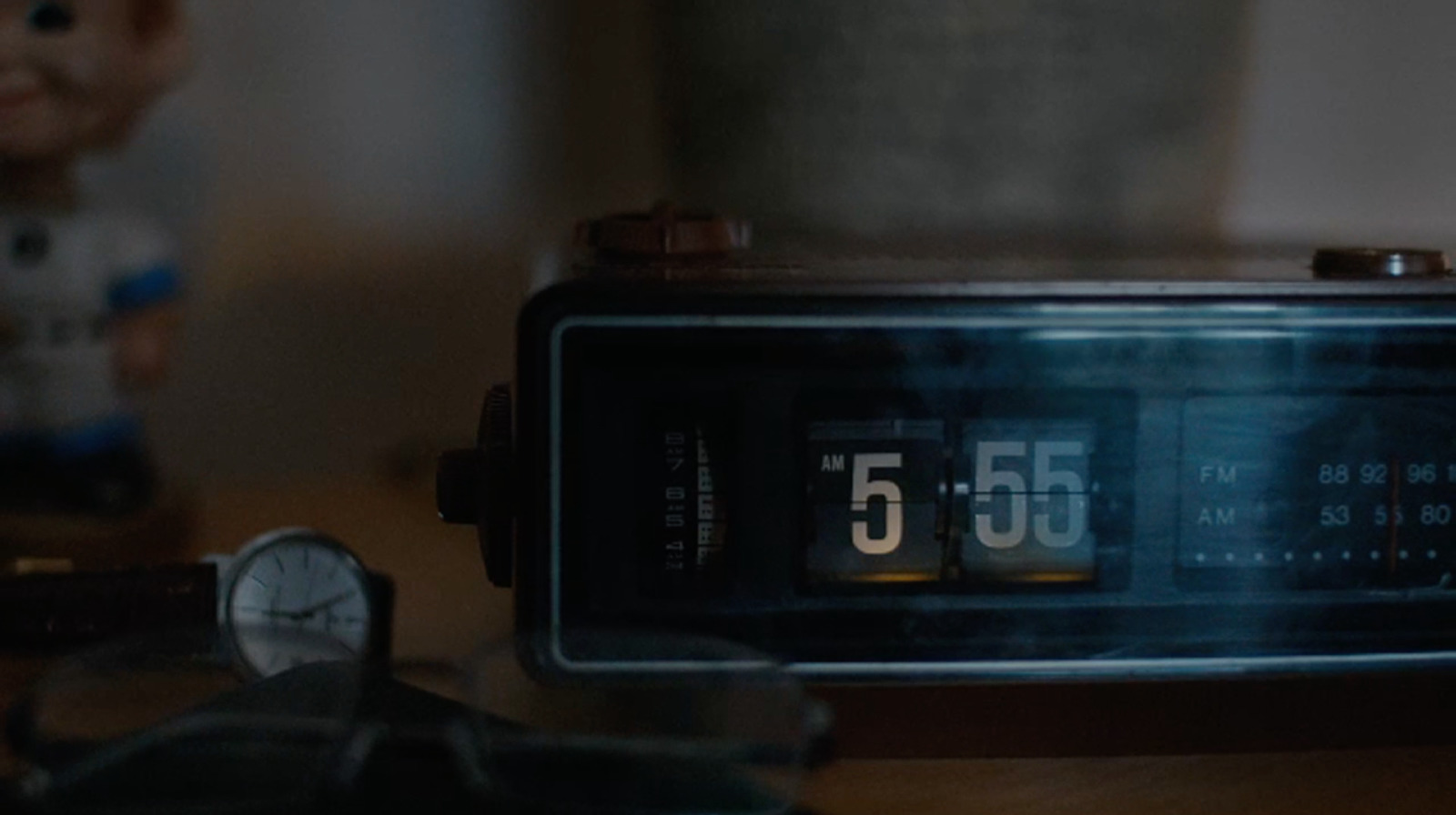 an alarm clock sitting on top of a wooden table