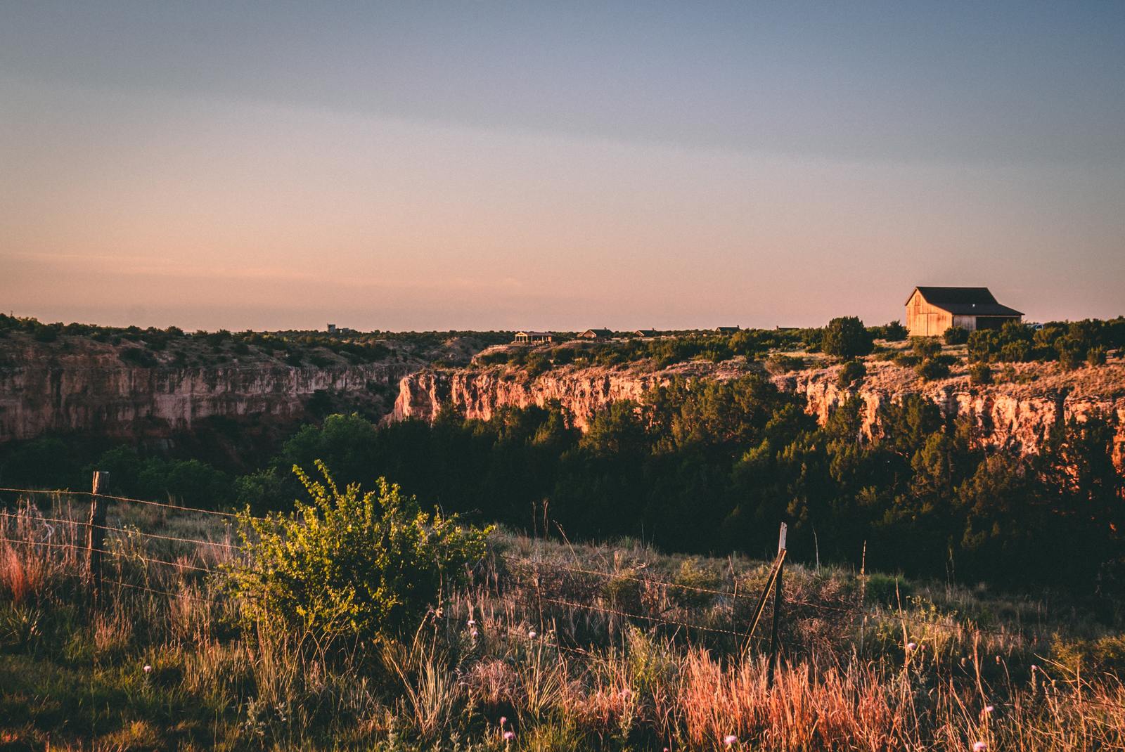 a house on top of a hill surrounded by trees